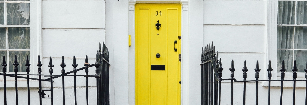 Yellow door of a townhouse.